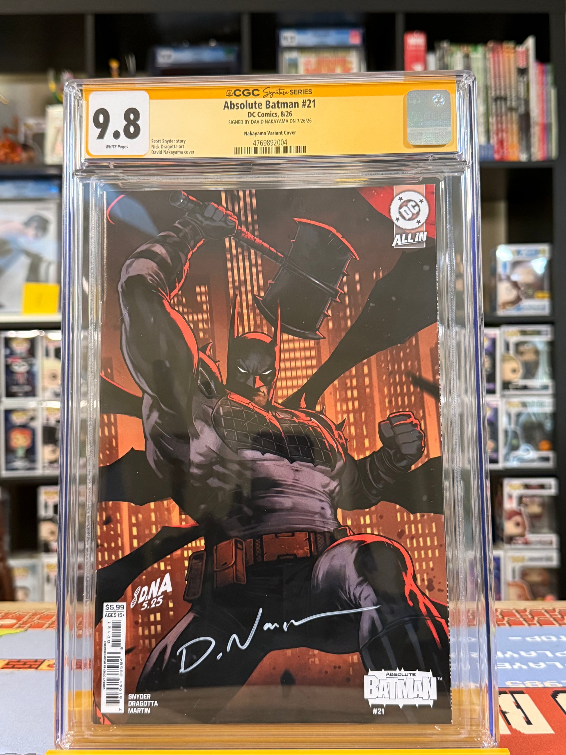 Absolute Batman #21 Cover B David Nakayama Connecting Card Stock Variant, CGC Signature Series 9.8 Yellow Label, signed by David Nakayama, featuring a muscular Batman raising his battle axe against an orange-lit Gotham City skyline