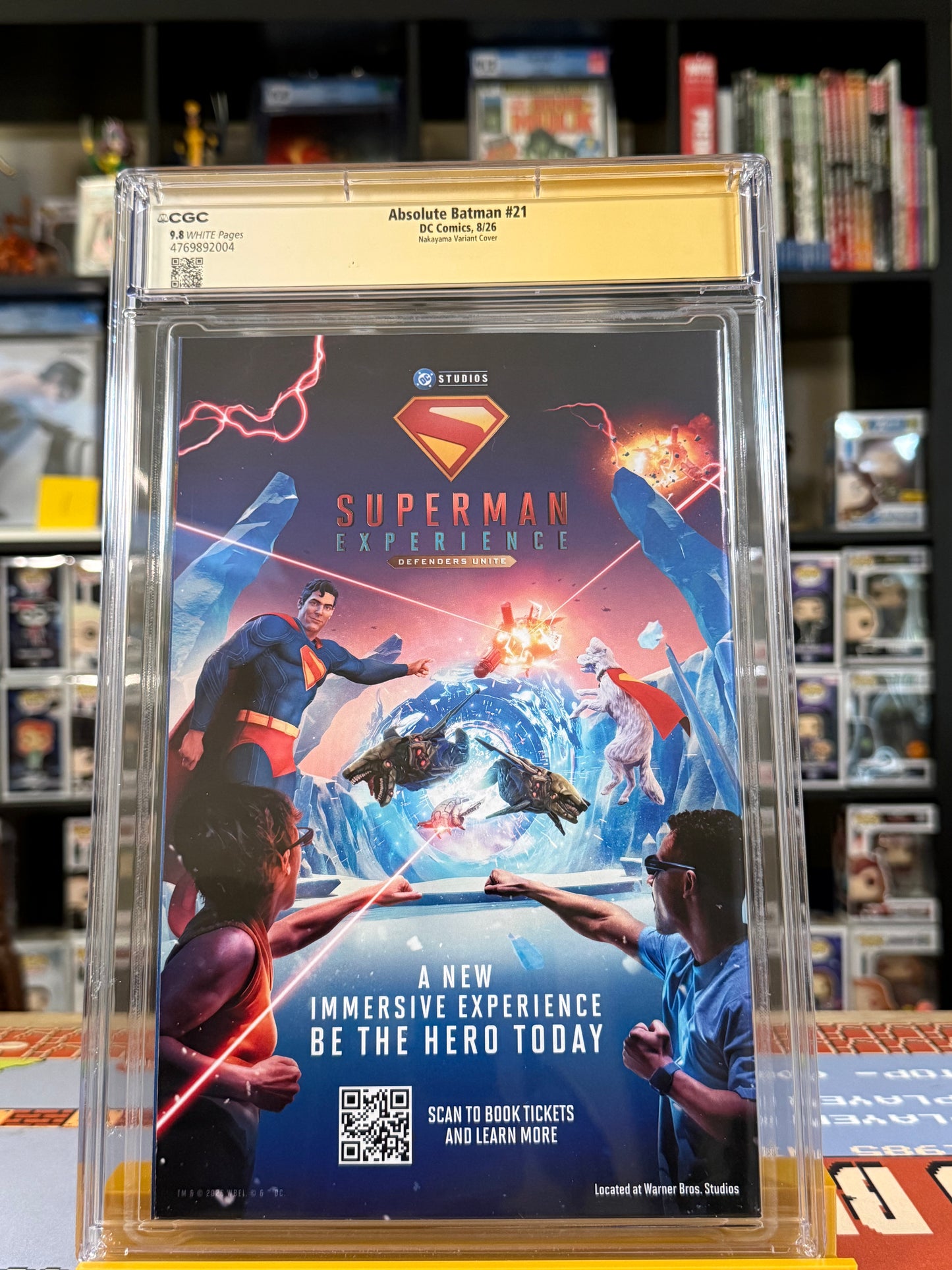 Absolute Batman #21 Cover B David Nakayama Connecting Card Stock Variant, CGC Signature Series 9.8 Yellow Label, signed by David Nakayama, featuring a muscular Batman raising his battle axe against an orange-lit Gotham City skyline