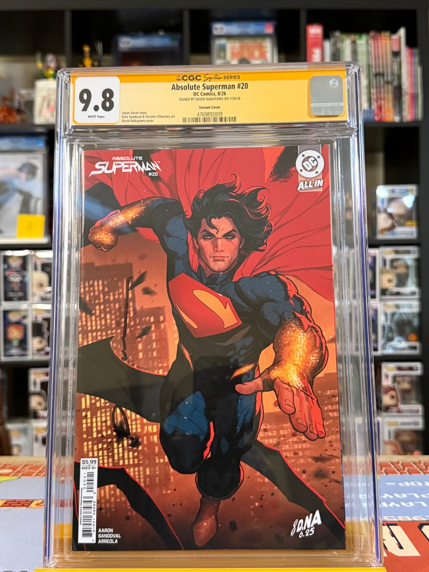 Absolute Superman #20 Cover B David Nakayama Connecting Card Stock Variant, CGC Signature Series 9.8 Yellow Label, signed by David Nakayama, featuring Superman flying forward with glowing golden arms against an orange-lit city skyline,