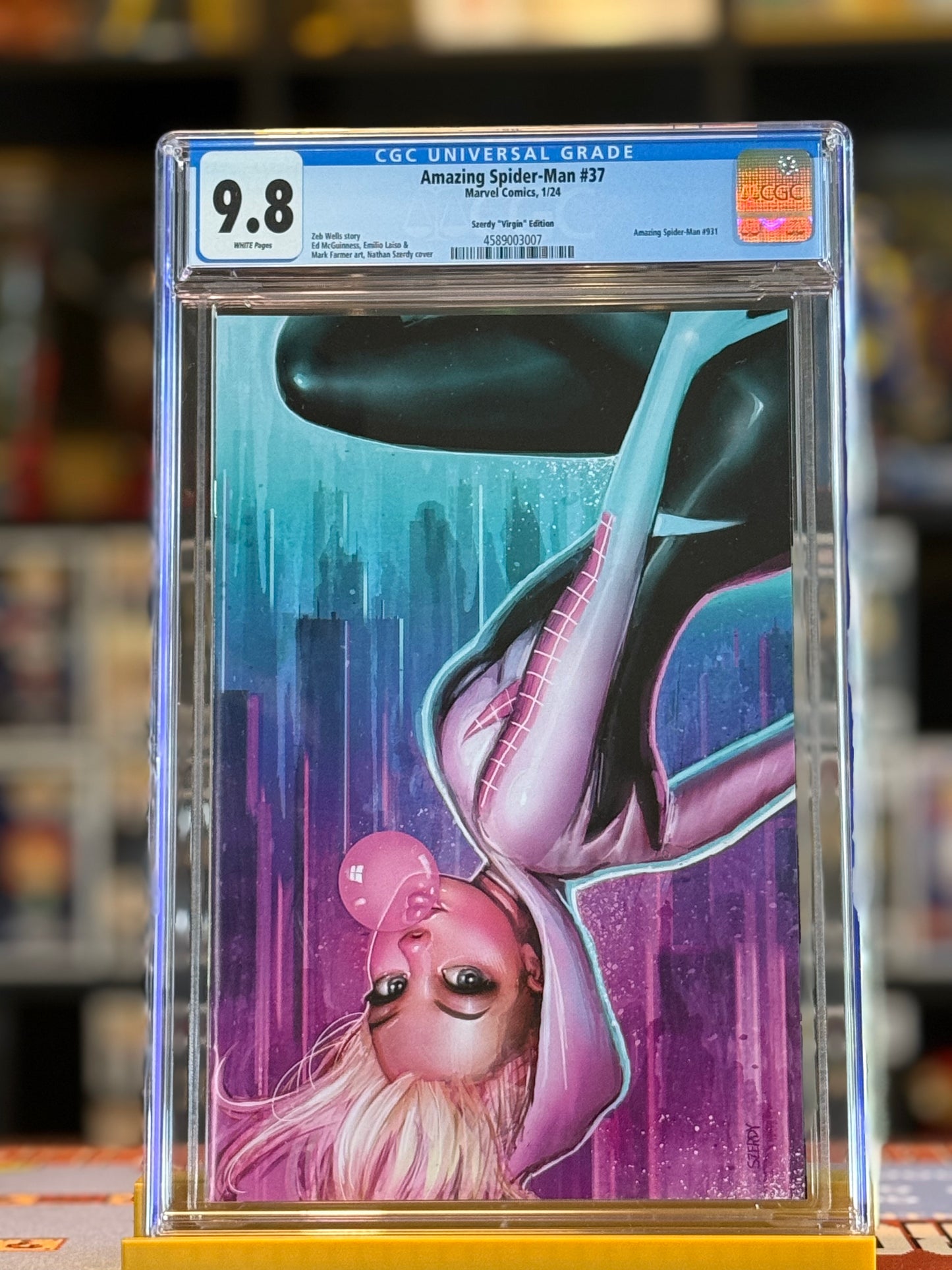 Image of Amazing Spider-Man #37 CGC 9.8 featuring a Virgin Variant cover of Spider-Gwen illustrated by Nathan Szerdy. Spider-Gwen is showcased in a dynamic pose with vibrant modern comic art, encapsulated in a CGC slab.