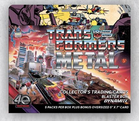 Transformers 40th Anniversary Metal Trading Cards Blaster Box by Dynamite Entertainment featuring Optimus Prime, Autobots, and Decepticons on colorful anniversary packaging, containing five trading card packs plus a bonus oversized 5 x 7 inch collectible card.
